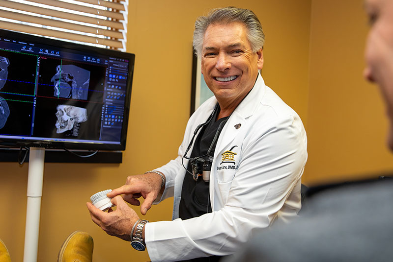 Doctor holding a model of teeth