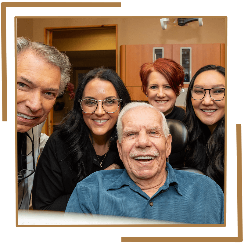 Patient Smiling into mirror with the team
