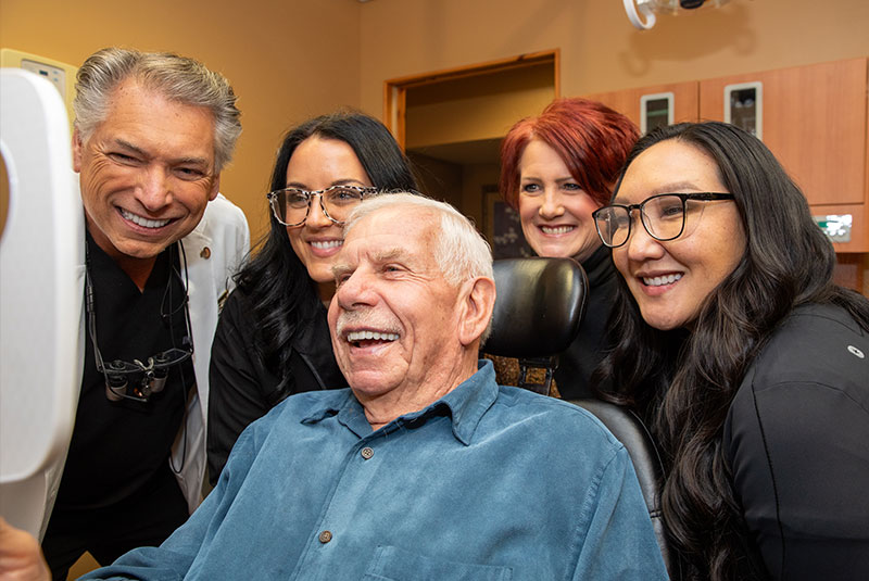 Team members and Patient Smiling into mirror